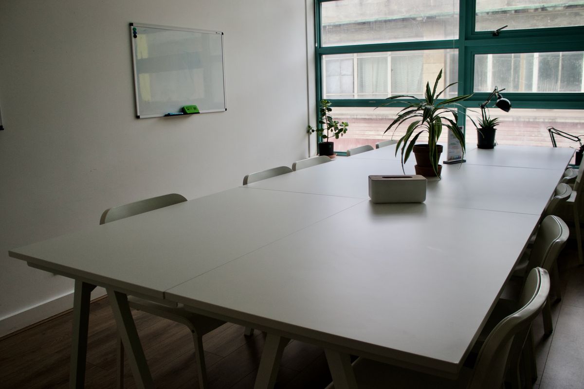Angell meeting room table and whiteboard at Impact Brixton
