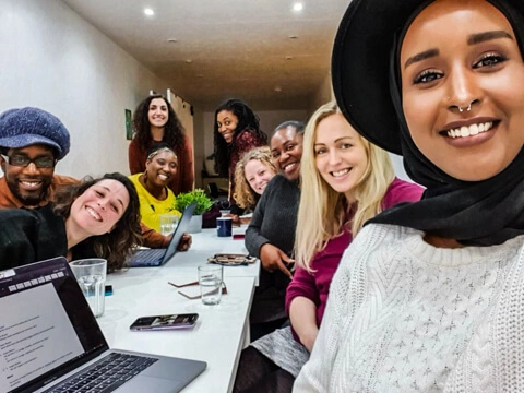 Impact Brixton community smiling in office space